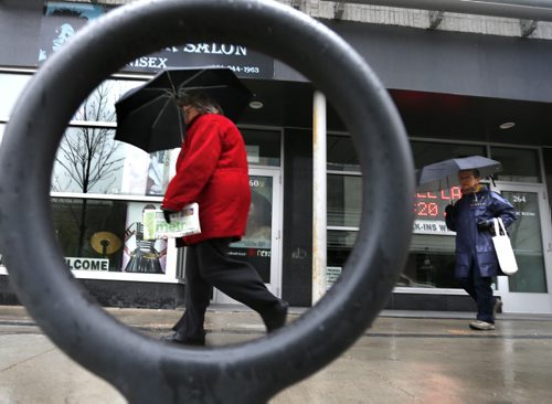 It will be an all around rainy day for Winnipeg as pedestrians pass by a bicycle stand on Edmonton Street on a wet Thursday morning.     Wayne Glowacki / Winnipeg Free Press May 14 2015