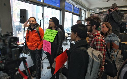 An environmental group disrupts the Winnipeg Free Press editorial board interview with Peter Watson the NEB Chair being held at the Winnipeg Free Press NewsCafe. 150514 May 14, 2015 Mike Deal / Winnipeg Free Press