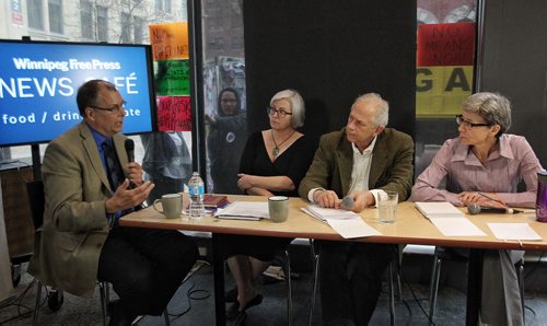 A protester holds up a sign during the Winnipeg Free Press editorial board interview with Peter Watson the NEB Chair at the Winnipeg Free Press NewsCafe.  150514 May 14, 2015 Mike Deal / Winnipeg Free Press