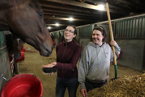 Young, female groomers Chantel Tkachyk (right, grey) and Miranda Truijen work with  race horses in the main barn at Assiniboine Downs.   See Story.  May 14, 2015 Ruth Bonneville / Winnipeg Free Press