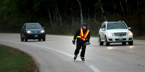 Rain or shine cold or hot Brendan McMahon skates the road around Bird's Hill Park. A rainy Thursday was no exception as the first big camping and parks weekend of the season is expected to be gloomy and cold. See story. May 14, 2015 - (Phil Hossack / Winnipeg Free Press)