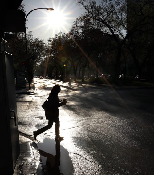 Blazing  sunshine early Friday morning reflects on the wet street of Broadway but more rain is in the forecast for the weekend.   Wayne Glowacki / Winnipeg Free Press May 15 2015