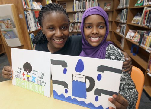 Acadia Junior high students Maltha Uwambajimana and Nasra Ahmed Sirja, purple scarf aretwo students of 13,000 in division who drew artwork that will be placed on floor of Investors Group Field  , next week,in shape of human rights logo. See Kevin Rollason story   May 15, 2015   (JOE BRYKSA / WINNIPEG FREE PRESS)