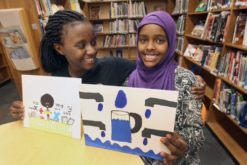 Acadia Junior high students Maltha Uwambajimana and Nasra Ahmed Sirja, purple scarf aretwo students of 13,000 in division who drew artwork that will be placed on floor of Investors Group Field  , next week,in shape of human rights logo. See Kevin Rollason story   May 15, 2015   (JOE BRYKSA / WINNIPEG FREE PRESS)