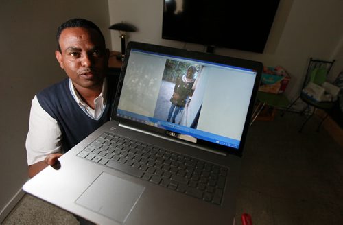 Teklzghi ("Tek") Yohannes shows a photo of his cousin Senait Gabir, 28, a fellow Eritrean who drowned in the Mediterranean in April. Sunday night there's a candlelight vigil for refugees who've died trying to get some place safe. See Carol Sanders story. May15, 2015 - (Phil Hossack / Winnipeg Free Press)