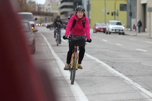 A cyclist makes their way down Garry toward Broadway Friday afternoon in the bike lane.  May 14, 2015 Ruth Bonneville / Winnipeg Free Press