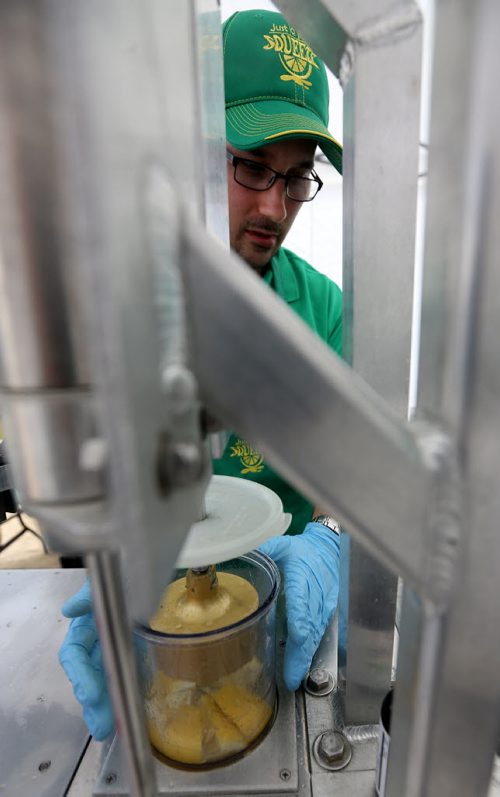 Joël Bouchard of Just a Little Squeeze uses a machine that squeezes the juice out of lemons to make fresh Lemonade at The St.Norbert Farmers Market, May 16, 2015. (TREVOR HAGAN/WINNIPEG FREE PRESS)