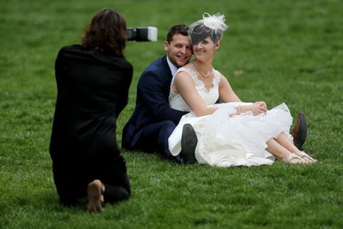 Candace Brodeur and Duane Gitzel have wedding photos taken by Krista Anderson in Old Market Square, Saturday, May 16, 2015. (TREVOR HAGAN/WINNIPEG FREE PRESS)