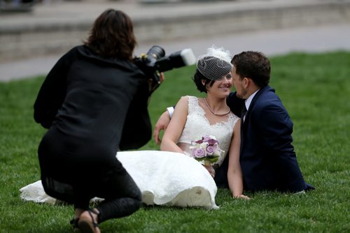 Candace Brodeur and Duane Gitzel have wedding photos taken by Krista Anderson in Old Market Square, Saturday, May 16, 2015. (TREVOR HAGAN/WINNIPEG FREE PRESS)
