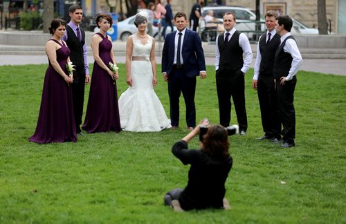 Candace Brodeur and Duane Gitzel have wedding photos taken by Krista Anderson in Old Market Square, Saturday, May 16, 2015. (TREVOR HAGAN/WINNIPEG FREE PRESS)