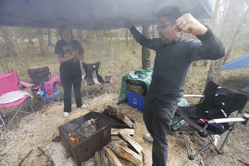 May 16, 2015 - 150516  -  May 16, 2015 Mike Wilwand celebrates after getting his camp fire started as his daughter Amber looks on during a PACE (Parents for Autistic Children Everywhere) family camp at Bird's Hill Park Saturday, May 16, 2015. John Woods / Winnipeg Free Press