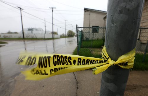 Remnants of Police Tape left on the 800 block of Alexander Avenue where the police had been investigating a homicide, Sunday, May 17, 2015. (TREVOR HAGAN/WINNIPEG FREE PRESS)
