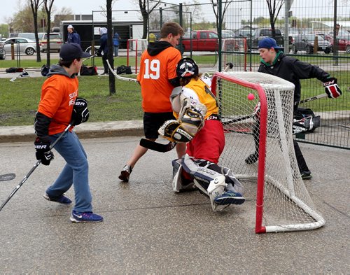 Tanner Wiebe, 16, of the Sunnyvale Stars scores a from behind the net by juggling the ball up on his stick during their game against the Sunova Beaches during the Play On! 4 on 4 Street Hockey Tournament at the University of Manitoba, Sunday, May 17, 2015. (TREVOR HAGAN/WINNIPEG FREE PRESS)