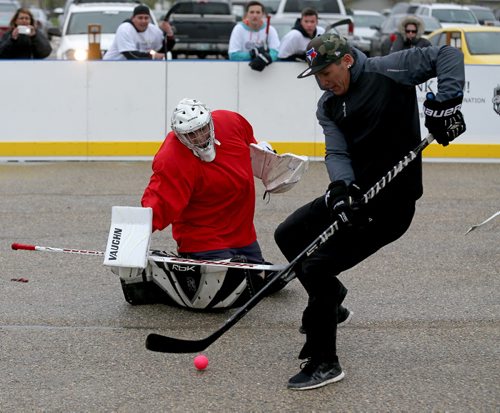 Goaltender Shane Dawson of Just Shoot tries to stop Desmond Lavalle of the High Flyers during the Play On! 4 on 4 Street Hockey Tournament at the University of Manitoba, Sunday, May 17, 2015. (TREVOR HAGAN/WINNIPEG FREE PRESS)