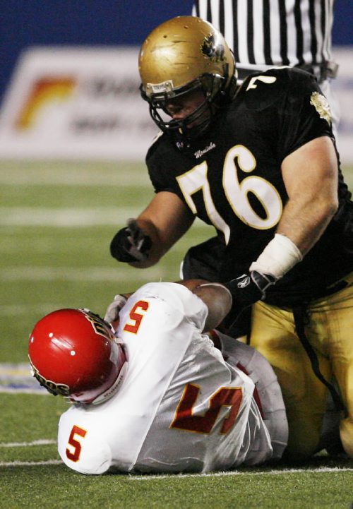 John Woods / Winnipeg Free Press / Nov 3/07- 071103  -  Manitoba Bisons Justin Cooper (76) gestures to Calgary Dinos Anthony Woodson (5) after he took him down in the second half of their semi final game in Winnipeg Saturday Nov 3/07.