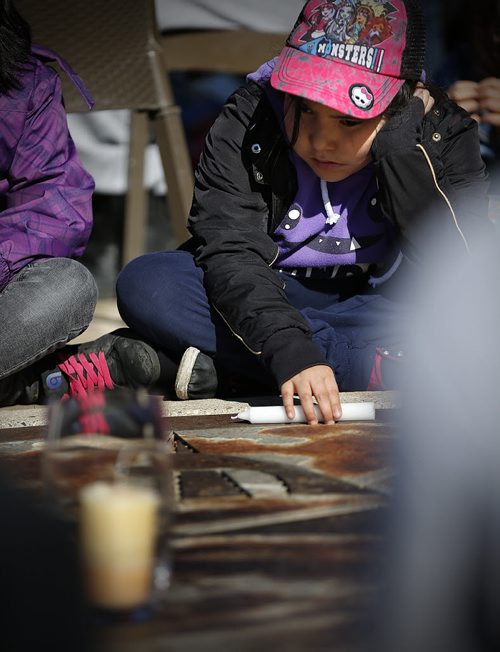 May 18, 2015 - 150518  -  Young girl looks at a vigil candle for Teresa Robinson. On Monday, May 18, 2015 people gathered at the Oodena Circle at the Forks for a vigil for Teresa Robinson, an eleven year old who was killed on the first nation community of Garden Hill. John Woods / Winnipeg Free Press