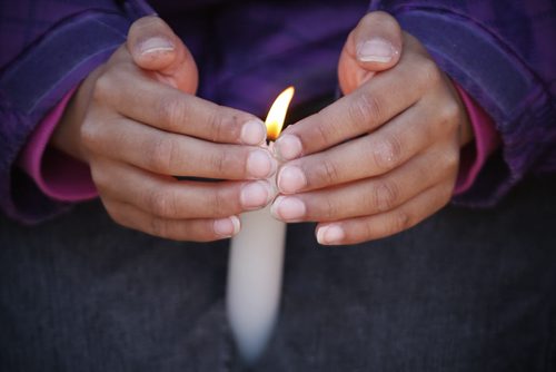 May 18, 2015 - 150518  -  A young girl protects the flame of his candle at a vigil for Teresa Robinson. On Monday, May 18, 2015 people gathered at the Oodena Circle at the Forks for a vigil for Teresa Robinson, an eleven year old who was killed on the first nation community of Garden Hill. John Woods / Winnipeg Free Press