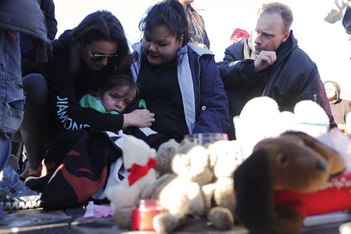 May 18, 2015 - 150518  -  A young child is comforted at a vigil for Teresa Robinson. On Monday, May 18, 2015 people gathered at the Oodena Circle at the Forks for a vigil for Teresa Robinson, an eleven year old who was killed on the first nation community of Garden Hill. John Woods / Winnipeg Free Press