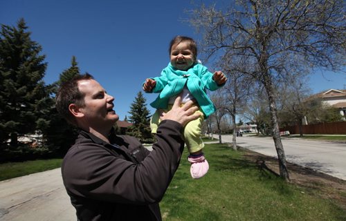 Chad Griffin plays with his ten-month-old girl, Desiree while out on a walk with her Tuesday afternoon in Linden Woods.  See Mary Agnes story on income gap within the city. May 19, 2015 Ruth Bonneville / Winnipeg Free Press