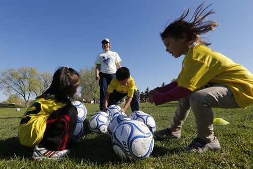 May 19, 2015 - 150519  -  Caitlyn Madzik (b/g) helps coach in a soccer program that encourages participation by inner-city girls Tuesday, May 19, 2015. John Woods / Winnipeg Free Press