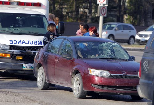 NEWS MVC pedestrian at Grant Ave.and Roblin Blvd. at around 7:30am. In photo is the people from the car that has windshield impact evidence. BORIS MINKEVICH/WINNIPEG FREE PRESS May 20, 2015