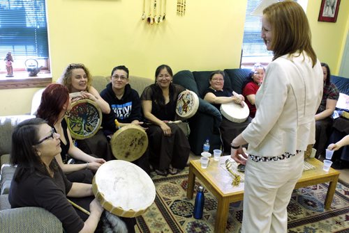Crowdfunding at the United Way press conference. Make it Happen drive. Media event at the North Main Women's Centre. Kevin Rollason story. (right standing) Volunteer Chair of United Way's 50th Anniversary Committee Ayn Wilcox speaks to members of the Buffalo Gals drumming group. BORIS MINKEVICH/WINNIPEG FREE PRESS May 20, 2015
