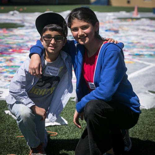 Urooba Salar, Grade 6 student at Beaumont Elementary School, poses with her brother and Grade 3 student Zaryab, in front of the panels their school that for, the Human Rights Logo - an art installation highlighting childrens human rights at Investors Group Field.  150520 - Wednesday, May 20, 2015 - (Melissa Tait / Winnipeg Free Press)