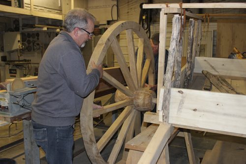 04 - Paul Barnabe and Leonard Pappel, of Emerson,  demonstrate how easily a wheel of a Red River Oxcart can be taken or or off.  BILL REDEKOP/WINNIPEG FREE PRESS May 15, 2015