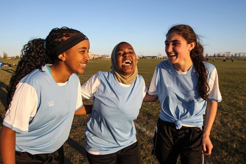 The Immigrant and Refugee Community Organization of Manitoba "IRCOM" Cobras under-16 girls soccer team playing the West St. Paul Stars U-16 team Wednesday evening. (l-r) Nasra, Noela, and Falanga joke around while having their photo taken. 150520 - Wednesday, May 20, 2015 -  (MIKE DEAL / WINNIPEG FREE PRESS)