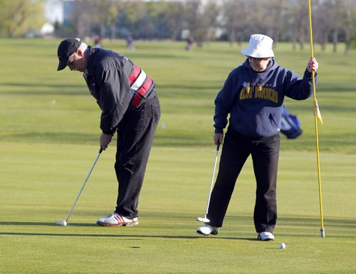 Peter Dercola and Betty Hughes play some golf at Assiniboine Golf Club Thursday morning. The two have been members at the club for over 30 years and enjoy the exercise in the morning. BORIS MINKEVICH/WINNIPEG FREE PRESS May 21, 2015