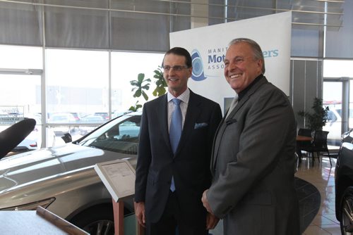 Consumer Protection Minister Ron Lemieux (right) and Steve Chipman, president, Manitoba Motor Dealers Association at press conference announcing new advertising rules that will be put into place as of June 1st to help protect buyers at Birchwood Toyota, Pointe West Auto Park Thursday.  See Bruce Owen's story.    May 21, 2015 Ruth Bonneville / Winnipeg Free Press