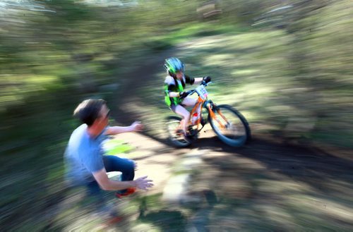 PHOTO FEATURE - Alter Ego Cycling Club President Allan Robertson reaches out to support a young rider in the "kids" portion of the Wednesday evening mountain bike races at Birds Hill Bird's Hill Park. May 20, 2015 - (Phil Hossack / Winnipeg Free Press)