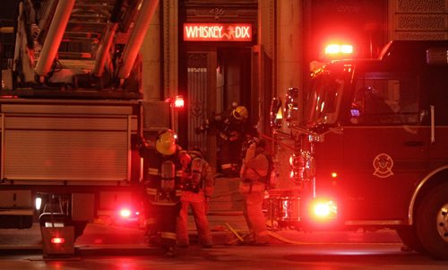 Winnipeg Fire Department crews work on putting out a fire at Whisky Dix on Main Street.  150521 May 21, 2015 Mike Deal / Winnipeg Free Press