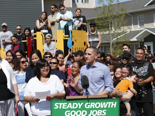 Kevin Chief, Jobs and the Economy Minister in front of a backdrop of community members and NDP Ministers in the Neeginan Village playground on Higgins Ave. Friday to announce the Manitoba government will move ahead with enhancements to the Rent Assist shelter benefit program that will help to promote employment, provide stability for families and reduce child poverty. These benefits will be increased in July and again in December. See   Bruce Owen story   Wayne Glowacki / Winnipeg Free Press May 22 2015