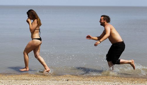 WINNIPEG BEACH -  Aime Varkerti gets chased by her friend Ben Figler on the beach. The two took advantage of the wonderful hot weather today. BORIS MINKEVICH/WINNIPEG FREE PRESS May 22, 2015