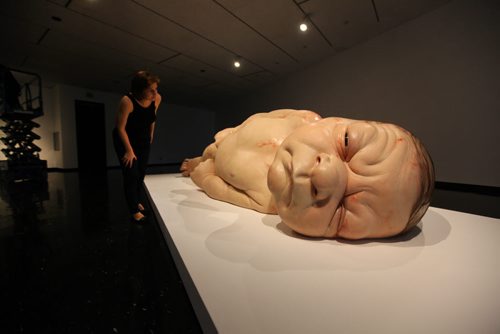 Winnipeg Art Gallery's PR Coordinator Tammy Sawatzky, takes a close look at Ron Mueck's exhibit of a newborn baby  titled "A Girl",   which is startlingly large yet very life-like at the WAG Friday.  Mueck is a UK-based Austrailian artist that creates realistic yet enigmatic sculptures that portray humans at key stages in life, from birth through middle age, to death.  The works are either monumental in scale or undersized.    May 22, 2015 Ruth Bonneville / Winnipeg Free Press