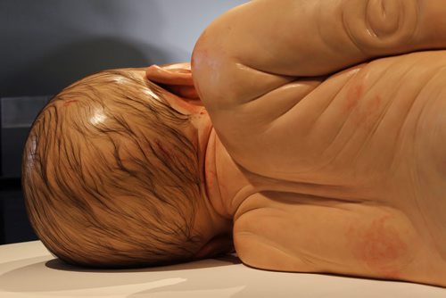 Views of Ron Mueck's exhibit of a newborn baby  titled "A Girl",   (back of head, hair, back and arms) which is startlingly large yet very life-like at the WAG Friday.  Mueck is a UK-based Austrailian artist that creates realistic yet enigmatic sculptures that portray humans at key stages in life, from birth through middle age, to death.  The works are either monumental in scale or undersized.    May 22, 2015 Ruth Bonneville / Winnipeg Free Press