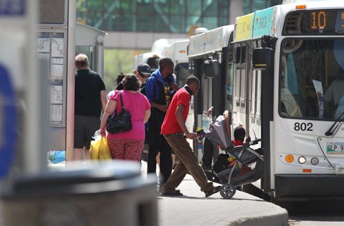 Winnipeg transit riders get on and off the bus in front of the MTS Centre Saturday.  For story on Winnipeg Transit drivers and the union.   May 23, 2015 Ruth Bonneville / Winnipeg Free Press