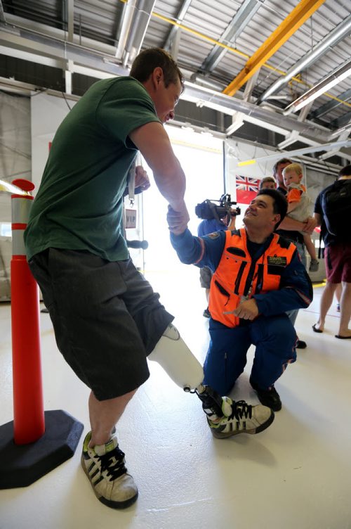 STARS air ambulance pilot Jason Graveline, signing the leg of Paul Neufeld, who lost his leg in a head on collision in November of 2012. Graveline was involved in the air call that day. Saturday, May 23, 2015. (TREVOR HAGAN/WINNIPEG FREE PRESS)