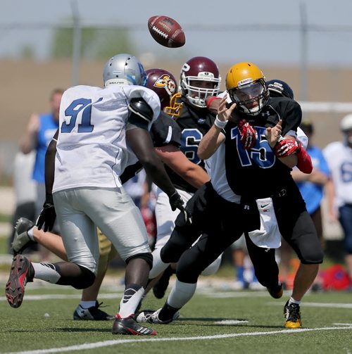 Braden Saindon, QB, who plays for the Steinbach Sabres, is sacked by Elvis Mingano, of the Elmwood Giants, during the WHSFL Senior Bowl at Eastside Field, Saturday, May 23, 2015. (TREVOR HAGAN/WINNIPEG FREE PRESS)