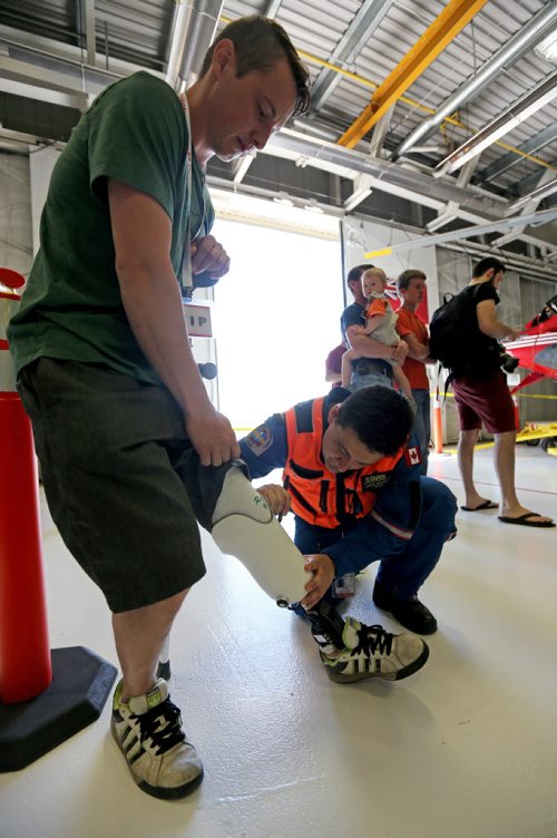 STARS air ambulance pilot Jason Graveline, signing the leg of Paul Neufeld, who lost his leg in a head on collision in November of 2012. Graveline was involved in the air call that day. Saturday, May 23, 2015. (TREVOR HAGAN/WINNIPEG FREE PRESS)