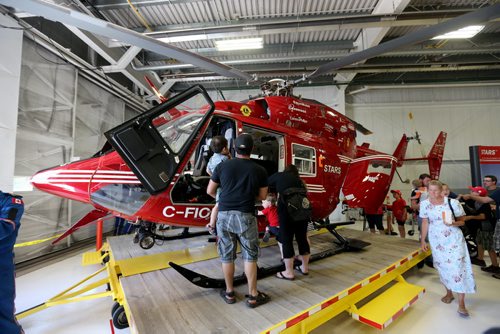 Visitors, pilots and nurses at the STARS hanger, Saturday, May 23, 2015. (TREVOR HAGAN/WINNIPEG FREE PRESS)