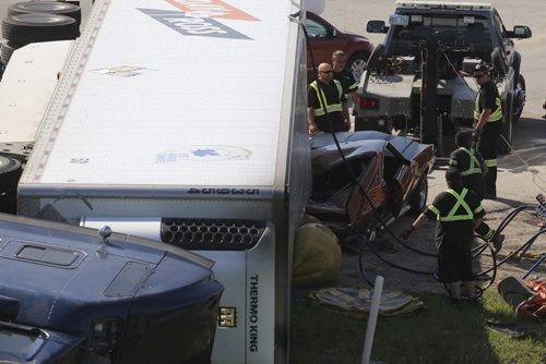 A semi-truck rolled over onto a car on the North Perimeter at Highway 59. RCMP at the scene said the crash happened around 8:30 a.m. Saturday morning, May 23, 2015. TREVOR HAGAN / WINNIPEG FREE PRESS
