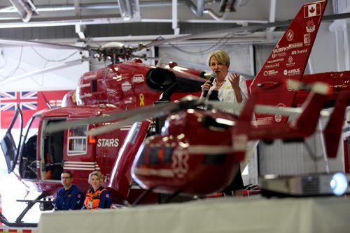 STARS CEO, Andrea Robertson speaking in front of an air ambulance inside their base Saturday, May 23, 2015. (TREVOR HAGAN/WINNIPEG FREE PRESS)