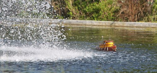 A model tugboat skirts the water fountain at the Duck Pond.  Members of the Winnipeg Model Boat Club gather every Sunday morning (and Wednesday evenings) to sail their boats on the Duck Pond at the Assiniboine Park. The radio operated boats range from kits you can order online to ones made from scratch. The club will be holding its 2015 Boat Regatta at the Duck Pond on Sunday, June 21st from 8AM - 4PM. 150524 May 24, 2015 Mike Deal / Winnipeg Free Press