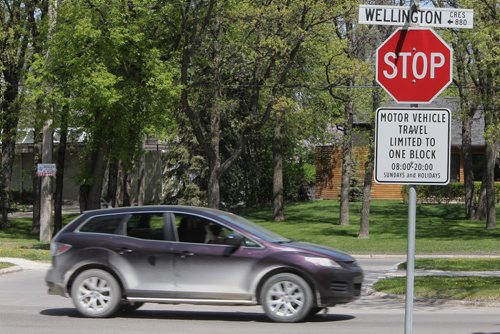 Motorists drive along Wellington Crescent Sunday which is now closed to vehicular traffic as the Sunday/Holiday Bicycle Street Closures by-law is in effect.   150524 May 24, 2015 Mike Deal / Winnipeg Free Press