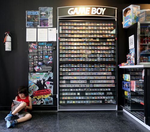 Jesse Murdock, 8, plays a game on an iPad while his brother waits to participate in a Super Smash Bros tournament at PNP Games on Portage Avenue, Sunday, May 24, 2015. (TREVOR HAGAN/WINNIPEG FREE PRESS)