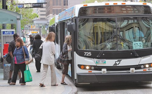 Transit riders get on and off a bus at the Graham Mall early Monday morning.  150525 May 25, 2015 Mike Deal / Winnipeg Free Press