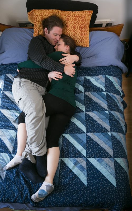 Bonnie Timshel and her partner Kristjan Anderson in a cuddle position called "the cocoon." The couple works for the Cuddlery, a new B.C.-based company that offers cuddle services to paying clients. Bonnie and Kristjan both have clients come to their apartment, or they travel to people's homes, to spend as short as 15 minutes to as long as three hours cuddling. 150520 - Wednesday, May 20, 2015 - (Melissa Tait / Winnipeg Free Press)