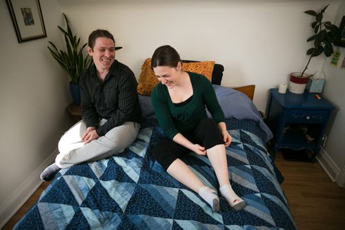 Bonnie Timshel and her partner Kristjan Anderson laugh pre-cuddle at home. The couple works for the Cuddlery, a new B.C.-based company that offers cuddle services to paying clients. Bonnie and Kristjan both have clients come to their apartment, or they travel to people's homes, to spend as short as 15 minutes to as long as three hours cuddling. 150520 - Wednesday, May 20, 2015 - (Melissa Tait / Winnipeg Free Press)
